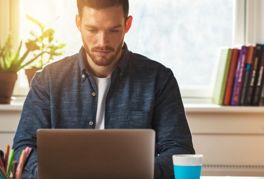 A man looking at his laptop